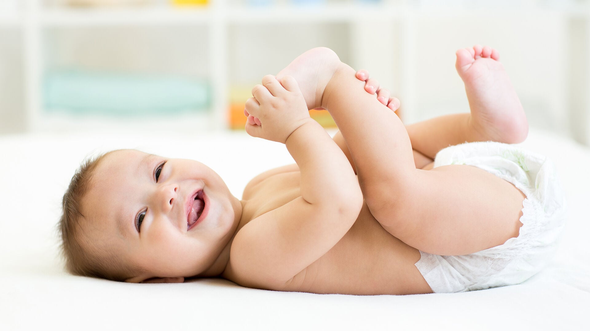 baby holding their feet